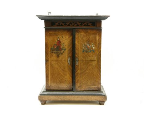 A B.H. Abrahams 'smoker's cabinet' disc musical box, 'The Britannia', playing 9in discs, in a two door cabinet, with stencill