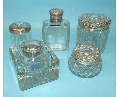 Three silver-mounted cut-glass trinket pots, a scent bottle with plated top and a silver-mounted glass inkwell, Birmingham 19