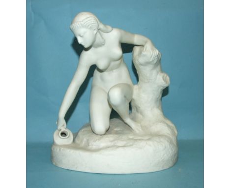 A parian figure of a nude female subject filling a pitcher with water, 25cm high. 