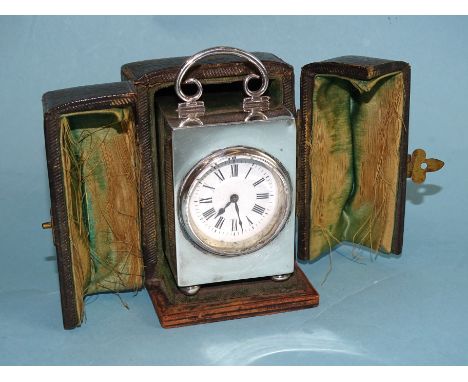 An Edwardian silver-cased dressing table clock, the plain rectangular case with C-scroll handle, on bun feet, 9.5cm, maker Do