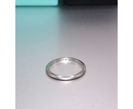 Tiffany &amp; Co, a platinum wedding band of bladed form, marked Tiffany &amp; Co. PT950, size K, 2.5g, in original case with