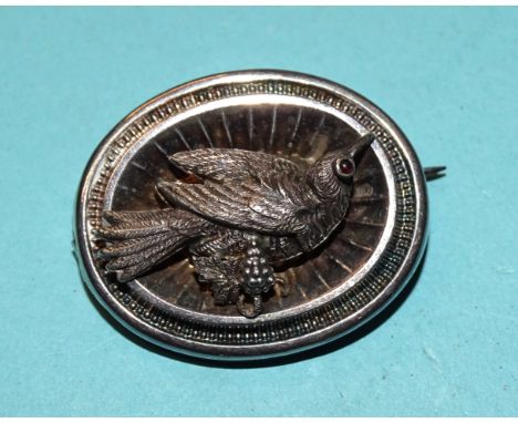 A Victorian silver locket-back brooch, a silver-mounted jade pendant on chain, a silver charm bracelet, a hardstone necklace 