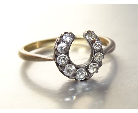 A Victorian diamond horseshoe ring, claw-set nine graduated old brilliant-cut diamonds in silver setting, on 18ct gold mount,