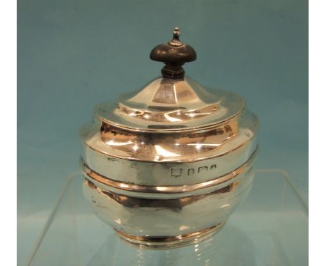 A silver lidded tea caddy of oval decahedral form, 11cm high, Birmingham 1903, ___4.9oz. 