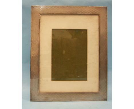 A rectangular engine-turned silver photograph frame, maker E Mander Ltd, Birmingham 1924. 