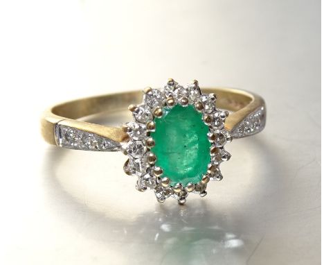 An emerald and diamond oval cluster ring with 9ct gold mount, size R, 2.6g. 