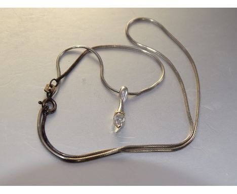 A diamond pendant set pendeloque-cut diamond, in yellow and white gold mount, 1.5g, on silver neck chain. 