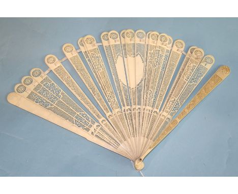 A 19th century ivory brisé fan, each stick finely pierced in geometric patterns, with central shield panel, the guards carved