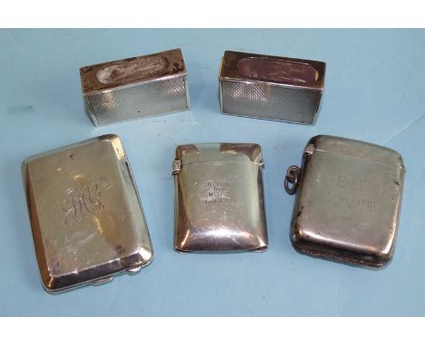 Two similar engine-turned silver small match box holders, Birmingham 1930/1936, two Vesta cases and a match book holder with 