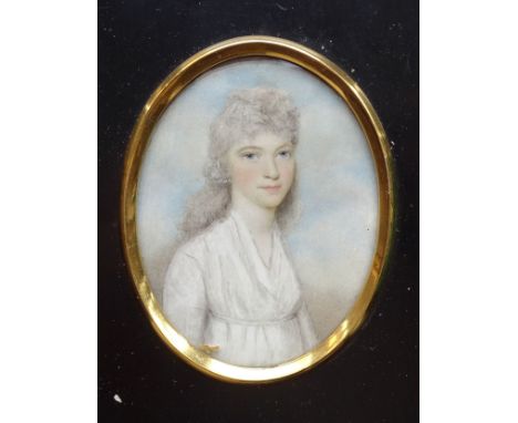 An early 19th century oval portrait miniature of a young woman wearing a white dress, three-quarter length 75 x 58mm, in oblo