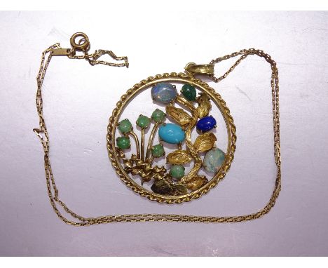 A 14k yellow gold circular pendant with flowers and leaves set jade, opals, turquoise and lapis lazuli, 39mm diameter, on 14k