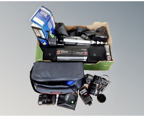 A box containing electricals including a Canon EOS 600 camera with lens, Ferguson radio cassette player, camera tripod, casse