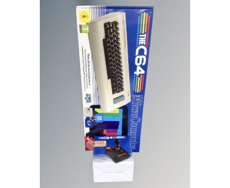 A The C64 micro computer with built-in games together with a C64 micro switch joy stick, both boxed 