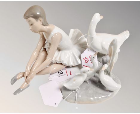 A Nao china figure : Seated Ballerina, height 13 cm, together with teo further Nao china both modelled as geese. (3)  