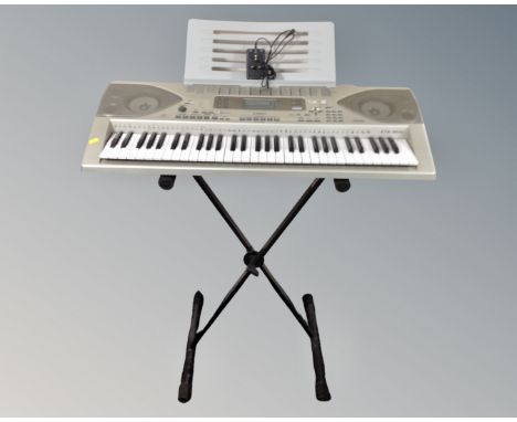 A Casio CTK-900 electric keyboard on stand with lead 