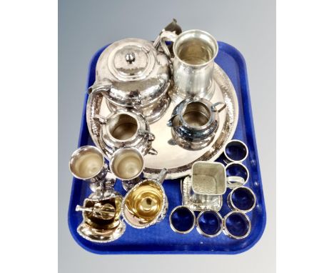 A tray containing plated wares including a three piece Art Deco tea service on tray, sugar helmet with scoop, napkin rings, t