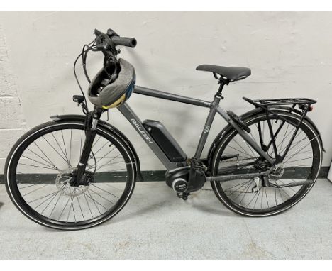 A Raleigh Motus tour electric bike powered by Bosch, with charger, fitted Axa block XXL rear bike lock with key, helmet and A