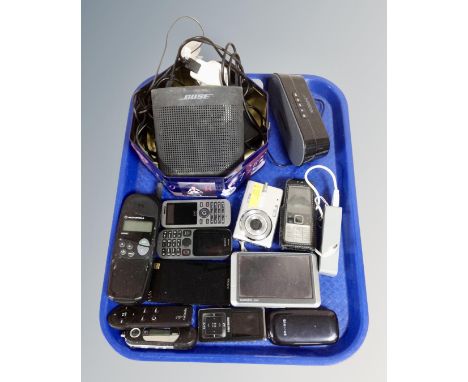A tray containing various electricals and mobile phones including Bose Soundlink speaker, HMDX bluetooth speaker, Garmin satn