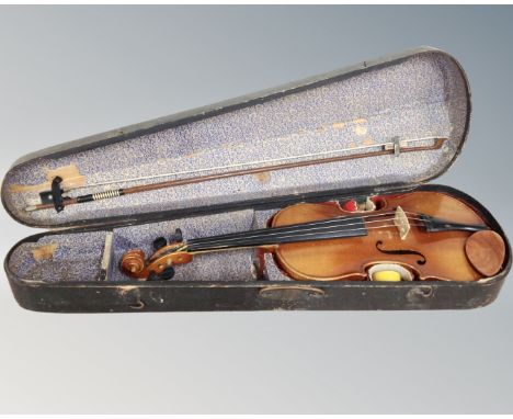 An early 20th century German violin, labelled Made in Germany Copy of Antonius Stradivarius, two-piece 14" back, with bow in 