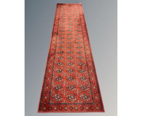 A machine-made Bokhara design runner, 91cm by 330cm.