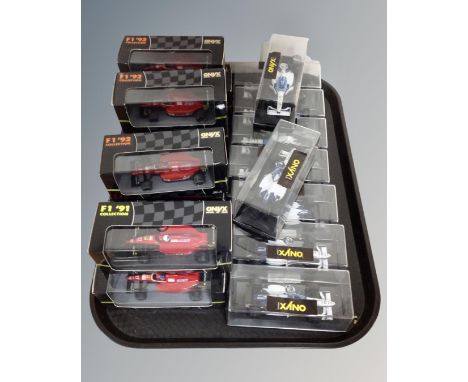 A tray containing 19 Onyx Formula 1 model cars in boxes and display cases.