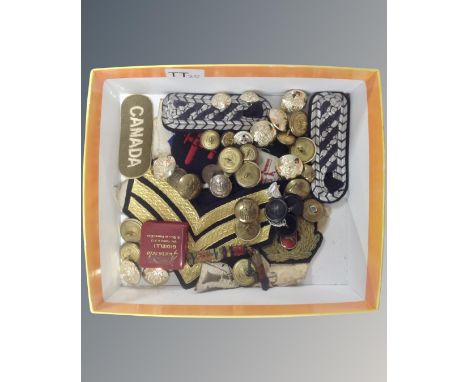 A box of mixed service button and sew on badges and insignias  