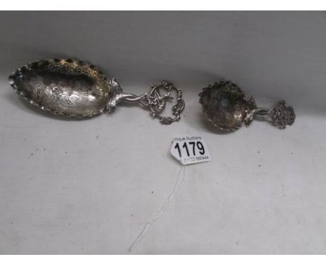 Two ornate silver caddy spoons. 