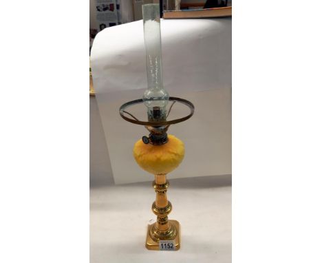 A Victorian peg font oil lamp on brass candlestick 