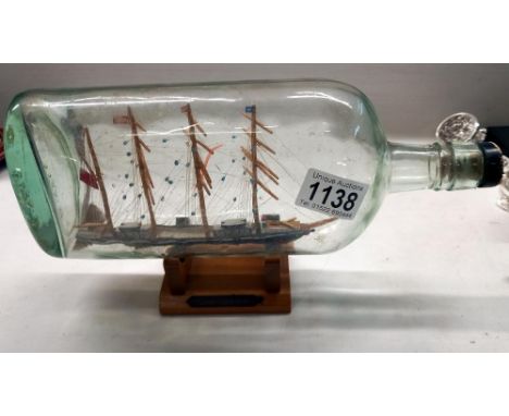 A vintage ship in bottle of a cutter circa 1700 