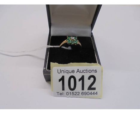 A 9ct gold diamond and green stone ring, size R, 2.1 grams. 