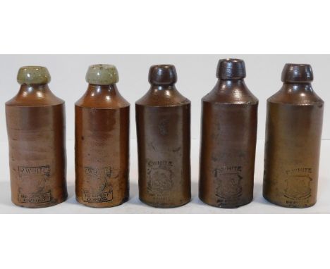 A collection of four 19th century stoneware lemonade bottles each impressed with the R. White name and trade labels to neck a