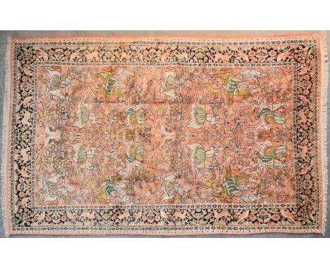 A Kashmir silk rug depicting a hunting scene on a blush ground contained within a stylised border. L.238x147cm 