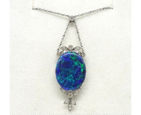 An antique opal and diamond drop pendant white gold setting, with centre large black opal approx. 18mm x 15mm, set within a d