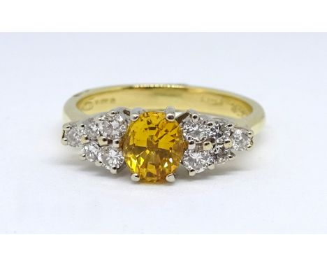 An 18ct yellow sapphire and diamond ring, size K.