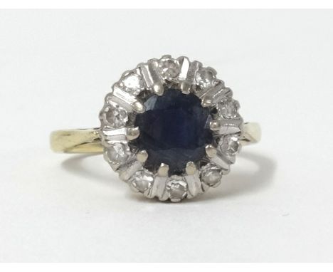 An 18ct sapphire and diamond cluster ring, size K.