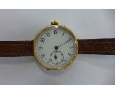An 18ct yellow gold wristwatch adapted from a pocket watch with ornate engraving, with gold dust cover, total weight approx 3
