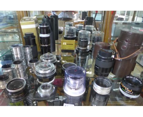 A collection of twenty one assorted camera lenses and attachments 