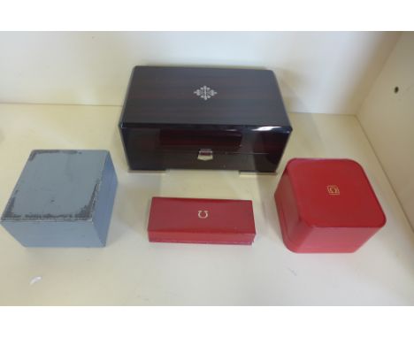 A Patek Philippe wooden watch box with highly polished finish, no insert, together with three vintage Omega watch boxes for g