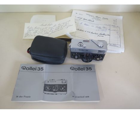 A Rollei 35 - 35mm camera with travel case and paperwork 