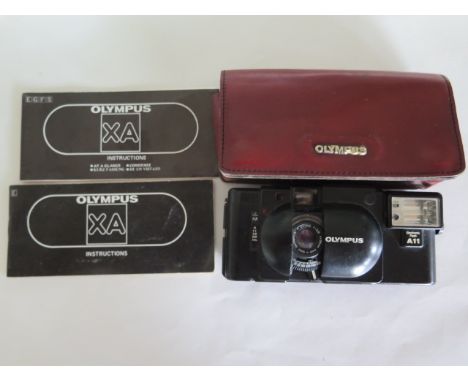 An Olympus XA 35mm camera with AII flash pouch and instructions 
