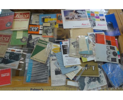 A collection of assorted camera booklets, including two Leica guides and a Leica catalogue and a Leica M2 and M3 leaflet 
