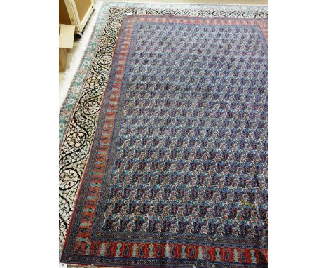 A West Persian carpet, with repeat botch field and narrow red ground boteh border, 212cm x 317cm. 