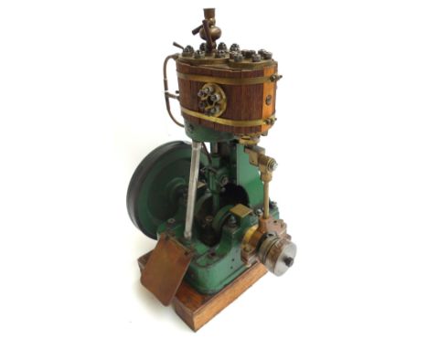 A scratch built vertical steam engine, early 20th century, with wooden clad boiler over a single piston and 7.5 inch fly whee
