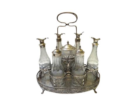 A Danish seven bottle cruet stand of wirework form, with a beaded rim and with a central wirework loop shaped handle, with as