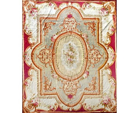 An Aubusson tapestry carpet, the central oval with a rose bouquet, shaped surrounds, ivory outer section with bouquets to cor