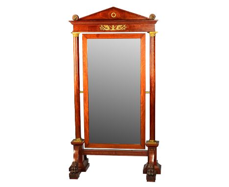 An empire ormolu mounted mahogany cheval mirror with architectural cornice and turned columns on four paw feet, 103cm wide x 