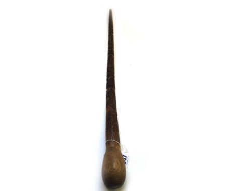 A Maori carved wooden walking stick, early 20th century, of tapering totem form, with a naturalistic bulbous pommel (90cm lon