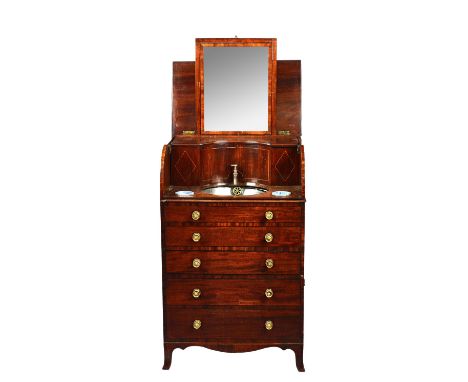 An early 19th century inlaid mahogany cylinder fronted washstand, the lift top enclosing a fitted interior with mirror basin 