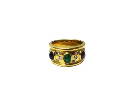 A gold ring, mounted with an oval cabochon sapphire, an oval cabochon emerald and an oval cabochon ruby and further set with 