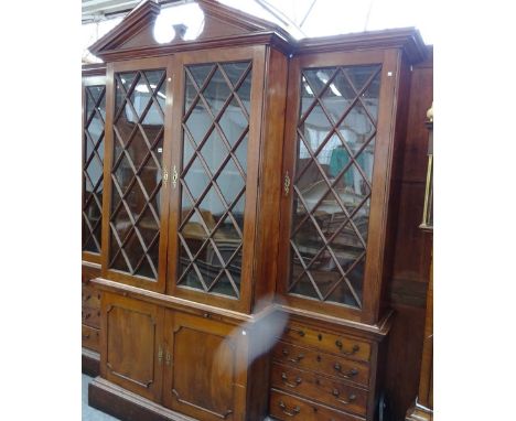 A George III and later mahogany bookcase, the architectural cornice over four astragal glazed doors over pair of cupboards, f